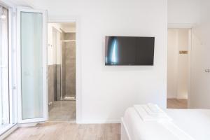 a white room with a television on a wall at Residence San Paolo in Rome