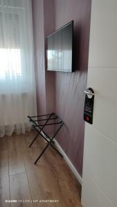 a mirror on a wall next to a refrigerator at VIP Apartment in Jagodina