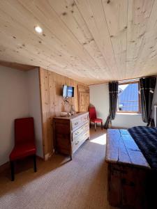 a bedroom with a bed and a wooden ceiling at Appartement Esprit Chalet 71m² in Briançon