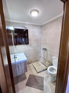 a bathroom with a toilet and a sink at Pavlos House in Symi