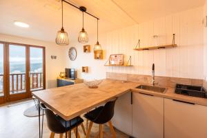 a kitchen with a wooden counter top and a table at Le Cocon du Llaret - Station de ski à pied in Les Angles