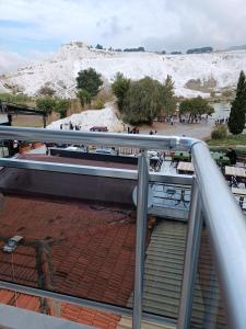 a balcony with stairs and a snow covered mountain at Pamukkale Sahin Boutique Hotel in Pamukkale