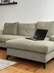 a laptop sitting on top of a couch at Charmante Altbauwohnung in Erlangen