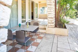a patio with a white table and chairs at Residenza Panorama in Costermano