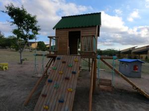 einen Spielplatz mit Spielhaus und Rutsche in der Unterkunft Flat Winterwille Gravatá in Gravatá