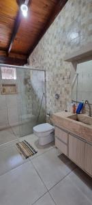 a bathroom with a shower and a toilet and a sink at Recanto das Araras, Transcendental in Bonito