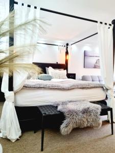 a bedroom with a large bed with a canopy at Neptun Studio-apartment with terrace. in Copenhagen