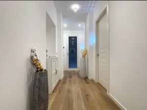 a hallway with white walls and a blue door at B and G San Babila luxury in the heart of Milano - Design district in Milan