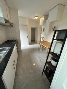 a kitchen and dining room with a table and a ladder at Tobacco Docks & St Katherine's Rooms in London