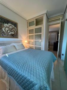 a bedroom with a large bed with a blue comforter at Cosy three bedroom bungalow in Costa Adeje in Adeje