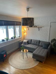 a living room with a couch and a table at Gästhuset Gubbhögen in Strömsund
