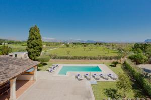 a villa with a swimming pool and lounge chairs at Villa Cifre in Alcudia