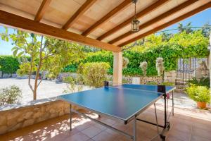 a blue ping pong table on a patio at Villa Cifre in Alcudia