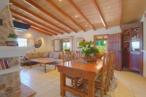 a kitchen and living room with a wooden table and chairs at Villa Cifre in Alcudia
