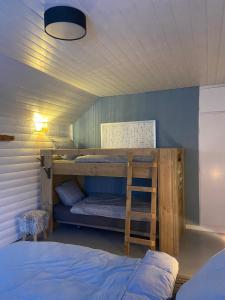 a bunk bed with a ladder in a room at Gästhuset Gubbhögen in Strömsund