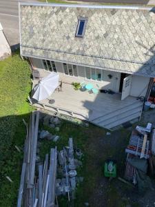 an overhead view of a house with a patio and an umbrella at Posthuset in Veblungsnes