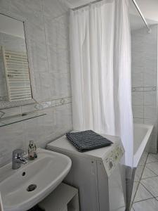 a white bathroom with a sink and a mirror at Apartment mea in Berlin +35 photos