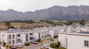 an aerial view of a building with mountains in the background at Le Citronnier - The Lemon Tree in Franschhoek