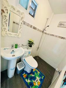 a bathroom with a toilet and a sink at The Kroun Seafront Residences 