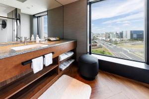 a bathroom with a sink and a large window at Hotel Metropolitan Tokyo Haneda - 2023-10-17 Grand Opening in Tokyo