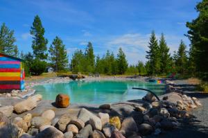 a large pool of water with rocks around it at Woodhouse Cottages And Ranch in Prince George