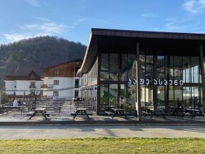 a building with tables and benches in front of it at Crystal resort b209 in Bakuriani