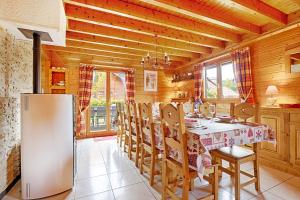 克松呂普隆熱默的住宿－Le Chalet des Cœurs - Avec vue montagne，厨房配有桌椅和冰箱。