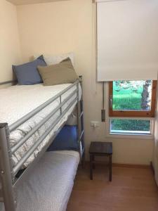 a small bedroom with a bunk bed and a window at Family Place, Next to Ski Lift & Mountain view! in Alp