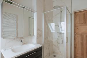 a bathroom with a sink and a shower at Amazing 2 ROOMS design apartement Loft in Ypres +21 photos