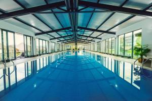 a large swimming pool with a large ceiling and windows at Crystal resort b209 in Bakuriani
