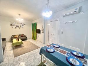 a living room with a blue table and a couch at WSD Glyfada Cozy 1BD Apartment with Balcony near Beach in Athens