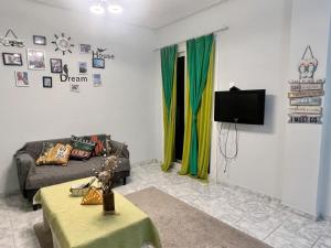 a living room with a couch and a tv at WSD Glyfada Cozy 1BD Apartment with Balcony near Beach in Athens