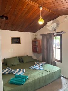 a bedroom with a green bed with two pillows on it at Sabine Holiday Resort and Restaurant in Matara