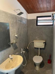 a bathroom with a toilet and a sink at Sabine Holiday Resort and Restaurant in Matara