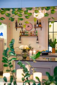 a kitchen with a counter with bottles on the wall at Park Hotel Linköping Fawlty Towers in Linköping