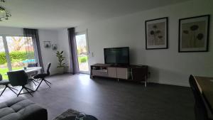 a living room with a television and a couch at Monteurwohnung in Bad Neustadt an der Saale