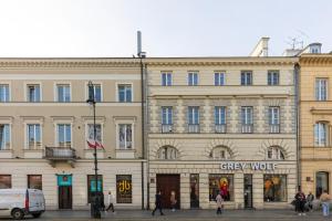 a large building with people walking in front of it at Cosy Apartment with Parking in the city centre Warszawa by Renters in Warsaw