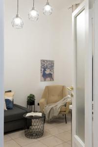 een woonkamer met een bank en een stoel bij Central Station Monza - Affitti Brevi Italia in Monza
