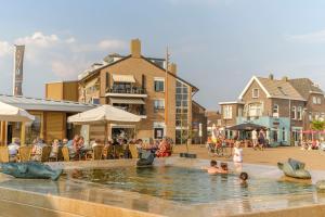 a group of people in a fountain in a town at De Noordzeekrab in Katwijk aan Zee