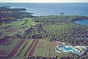 an aerial view of a field and the ocean at Casa Colone in Bale