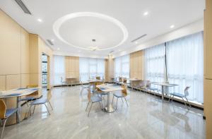 a conference room with tables and chairs and windows at Holiday Inn Express Chongqing Guanyinqiao , an IHG Hotel in Chongqing