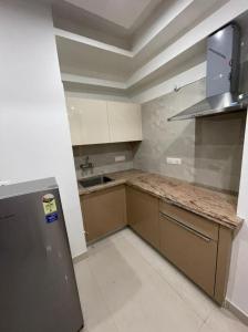 a kitchen with a refrigerator and a counter top at Minato Homz in Gurgaon