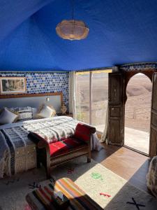 a bedroom with a bed in a blue tent at AGAFAY BIV FOLK & SPA by WE CAMPS in Ourika