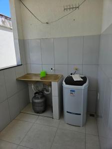 a small bathroom with a sink and a trash can at ARCO IRIS KITNETS in Fortaleza