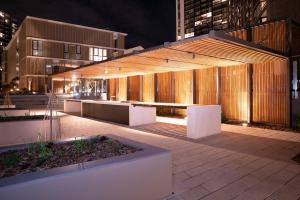 a building with a pavilion in a city at night at Modern 2 Bedroom Apartment Darling Square in Sydney