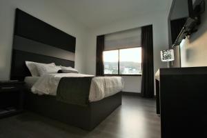 Postel nebo postele na pokoji v ubytování Hotel San Fernando Real