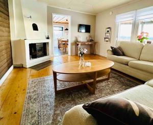 a living room with a couch and a coffee table at Villa Kakelbont! in Föllinge