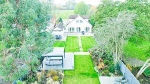 an aerial view of a white house with a yard at Pass the Keys Spacious House Near Chelmsford in Chelmsford