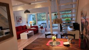 sala de estar con sofá rojo y mesa en Chalet Rotfuchs, en Braunlage