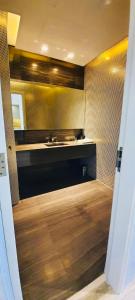 a kitchen with a sink and a wooden floor at One bedroom apartment - DAMAC TOWER in Riyadh